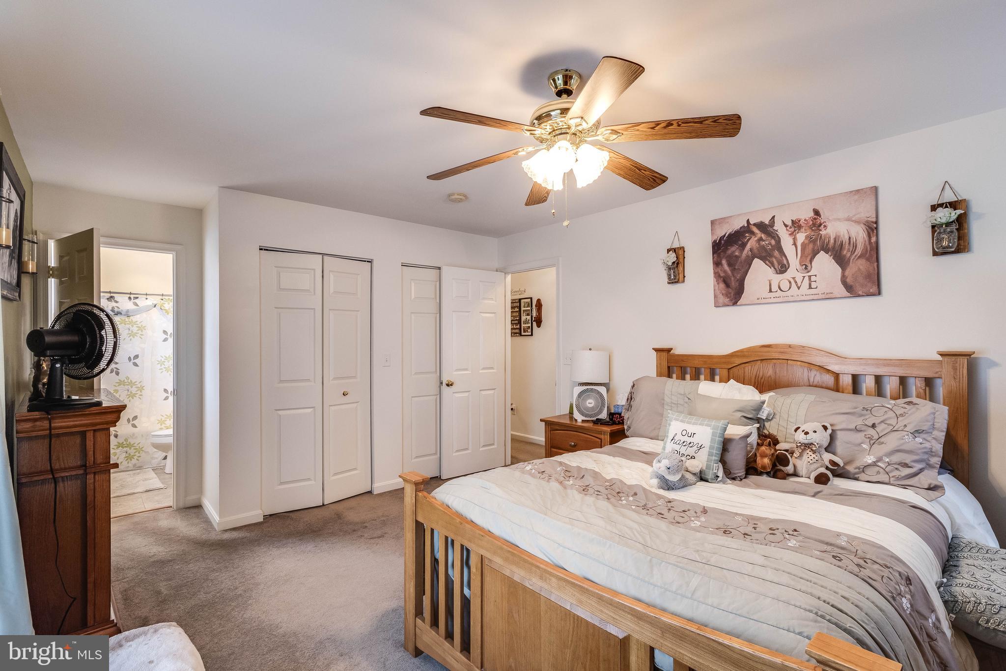 4757 Long Swamp Road Federalsburg, MD 21632 - Photo 13 of 47 a bedroom with a bed and a chandelier