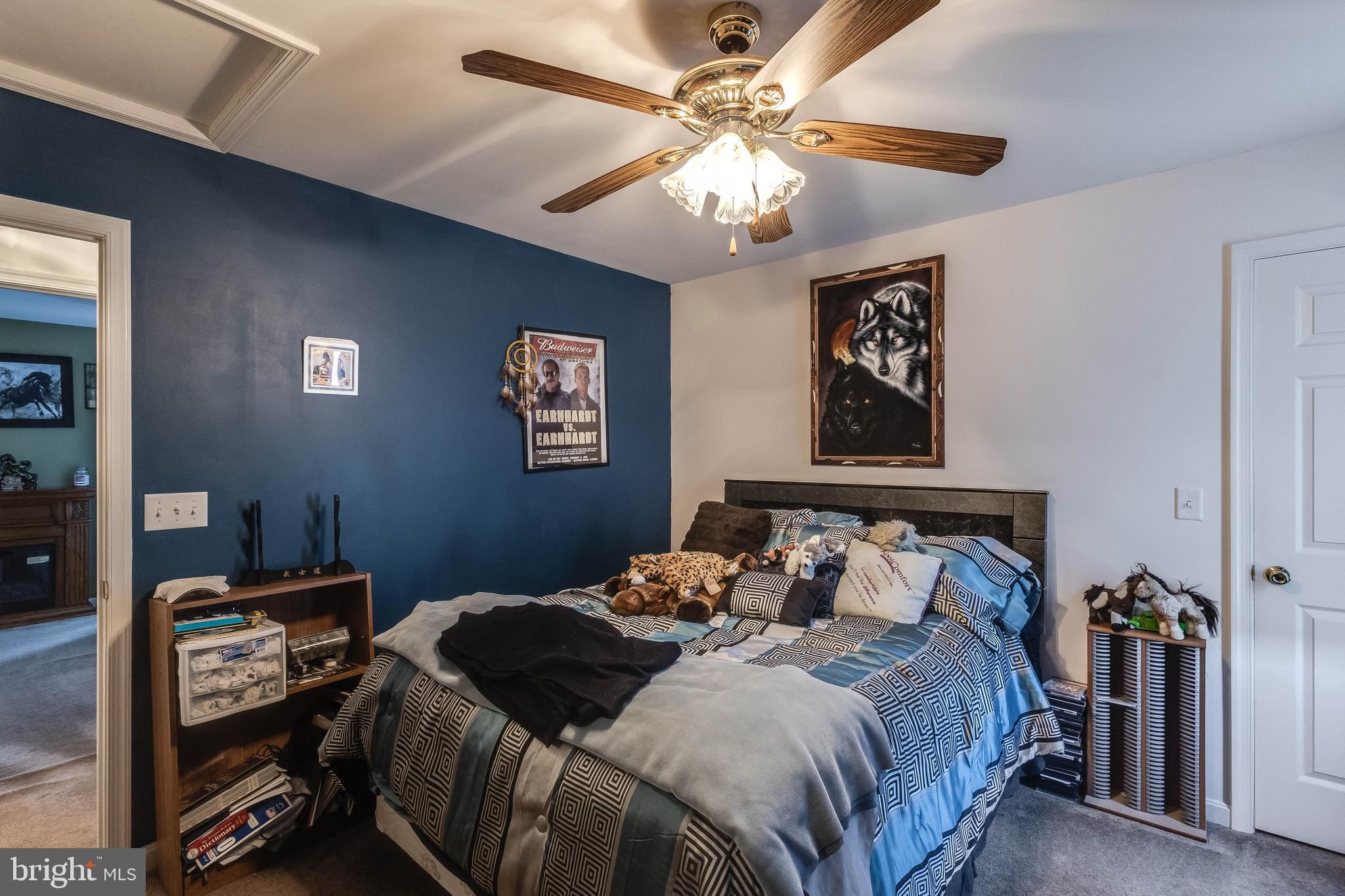 4757 Long Swamp Road Federalsburg, MD 21632 - Photo 16 of 47 a bedroom with a bed and a chandelier