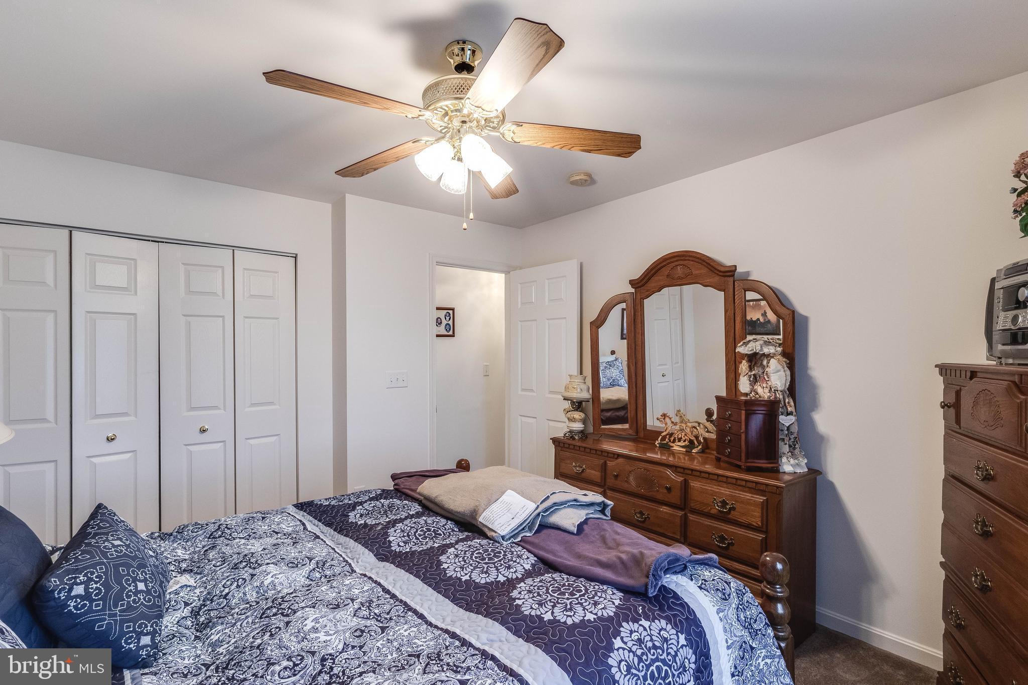 4757 Long Swamp Road Federalsburg, MD 21632 - Photo 18 of 47 a bedroom with a bed and a chandelier