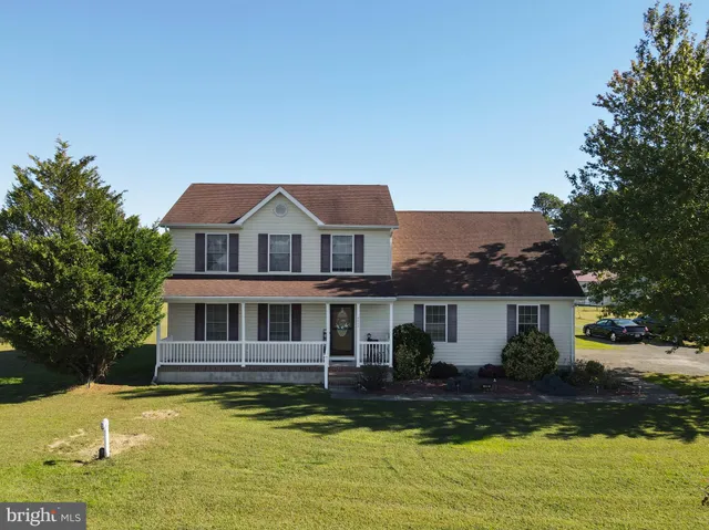 a front view of a house with a yard table and chairs