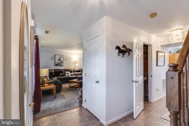 a view of a hallway to a livingroom and a livingroom with furniture