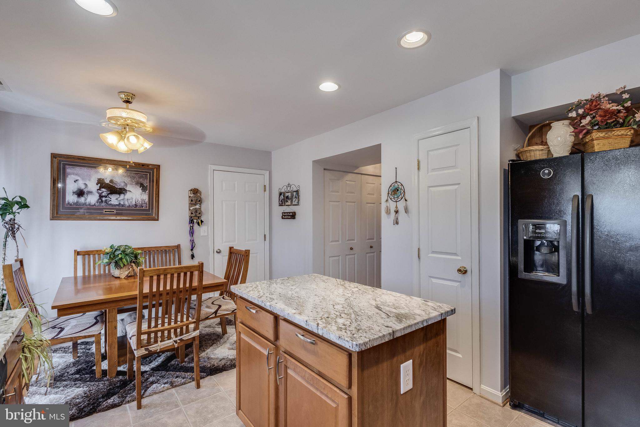 4757 Long Swamp Road Federalsburg, MD 21632 - Photo 8 of 47 a kitchen that has a kitchen island wooden cabinets and stainless steel appliances