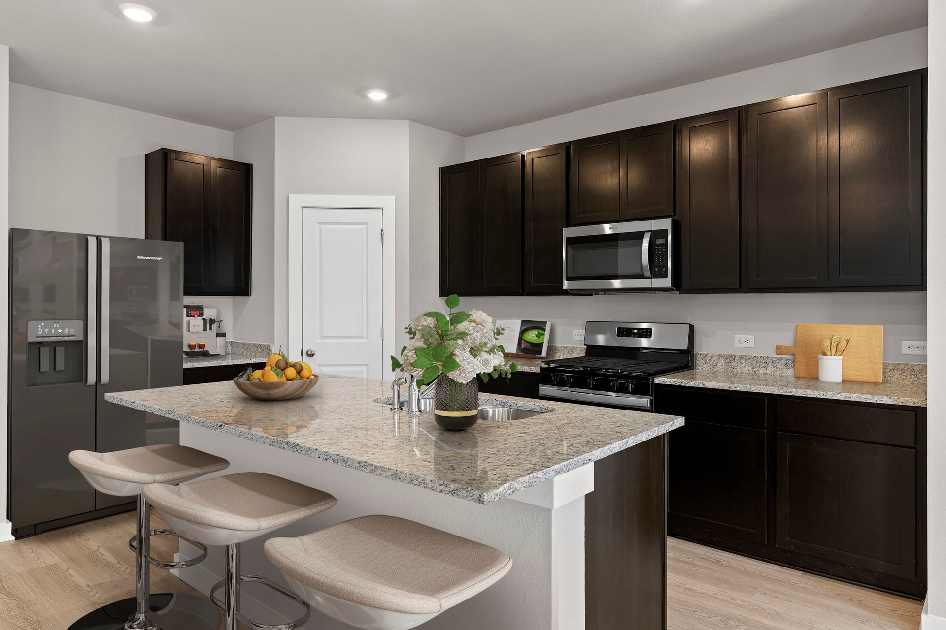 13613 Gray Landing Drive Elgin, TX 78621 - Photo 5 of 33 a kitchen with sink a refrigerator and chairs