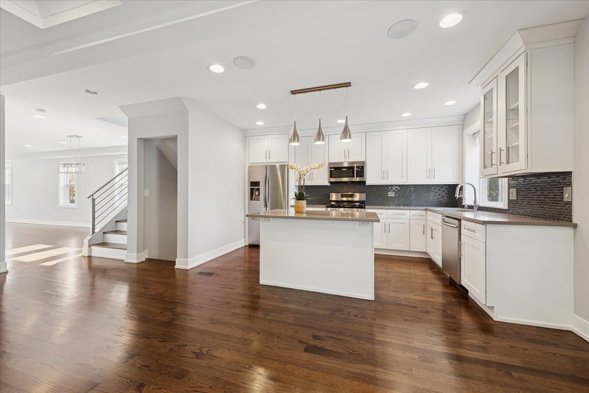 3254 North Rutherford Avenue Chicago, IL 60634 - Photo 11 of 29 a kitchen with stainless steel appliances white cabinets granite counter tops and a stove