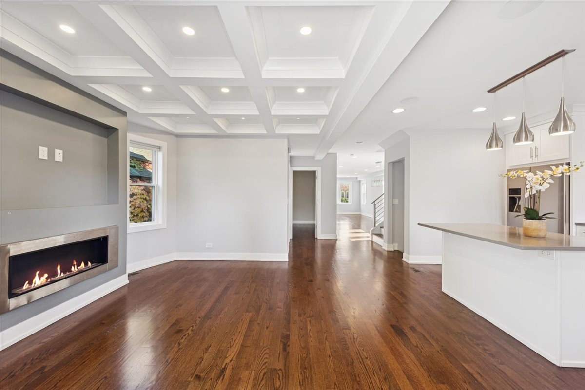 3254 North Rutherford Avenue Chicago, IL 60634 - Photo 12 of 29 a view of a hallway with wooden floor and a fireplace
