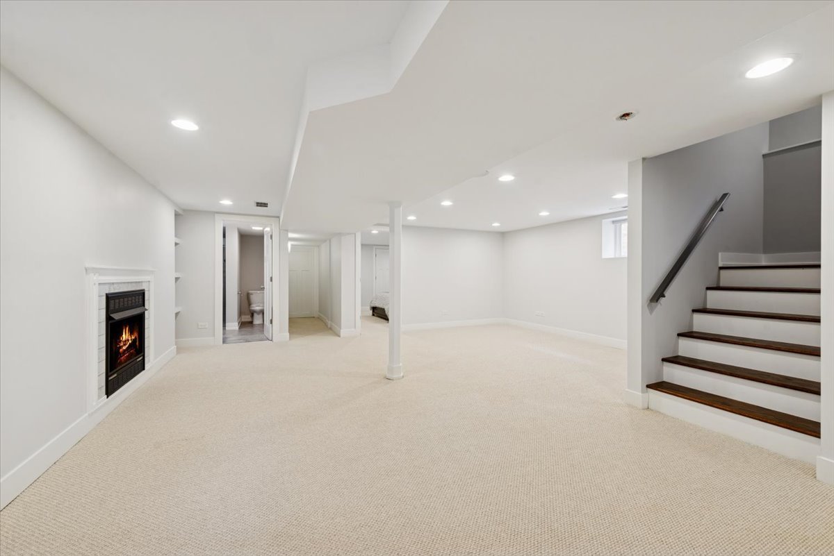 3254 North Rutherford Avenue Chicago, IL 60634 - Photo 21 of 29 a view of an empty room with wooden floor and a kitchen
