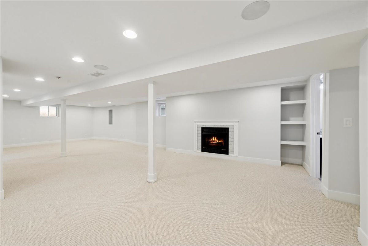 3254 North Rutherford Avenue Chicago, IL 60634 - Photo 22 of 29 an empty room with a fireplace and cabinet