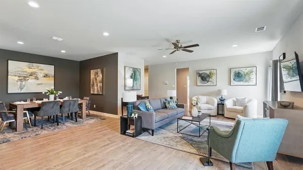 a living room with furniture and wooden floor