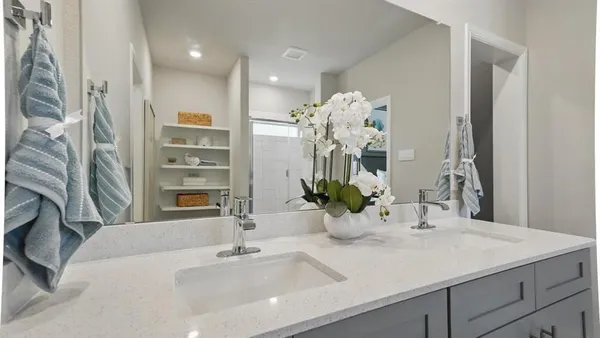 a bathroom with a sink double vanity and a mirror
