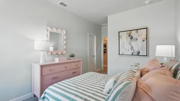 a bedroom with a bed and a painting on the wall