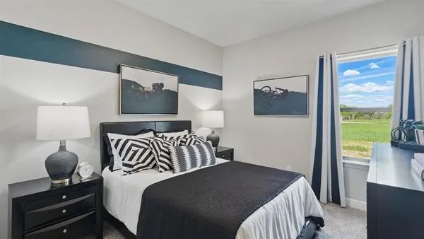 a bedroom with a bed and a large window