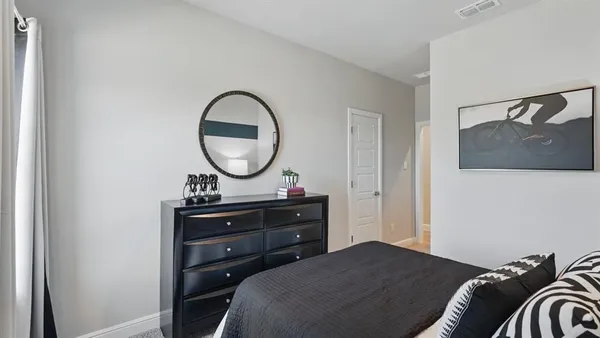 a bedroom with a bed and a dresser