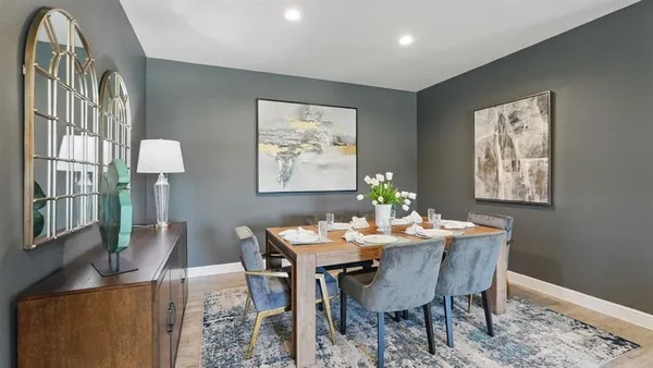 a dining room with furniture and window