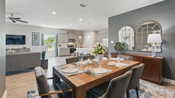 a dining room with furniture a window and a chandelier