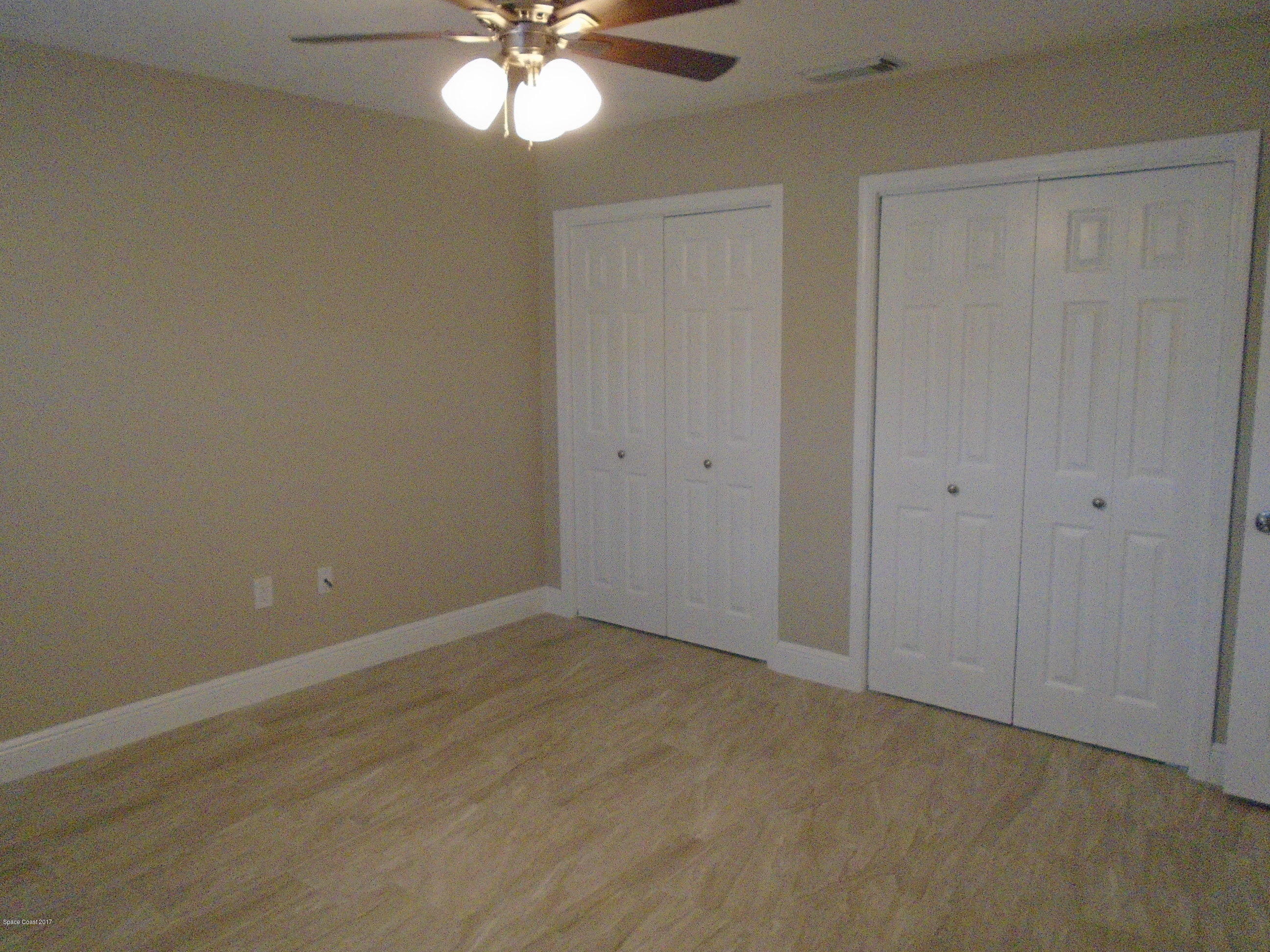 5600 North Banana River Boulevard, Unit 46 Cocoa Beach, FL 32931 - Photo 12 of 13 a view of an empty room with a chandelier fan