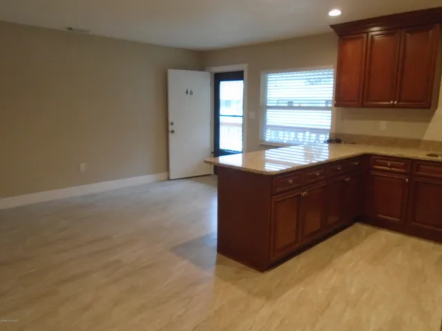 a kitchen with granite countertop a sink and cabinets