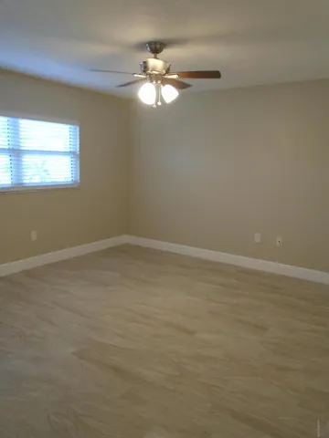 a view of a room with window and wooden floor