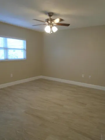 a view of a room with window and wooden floor