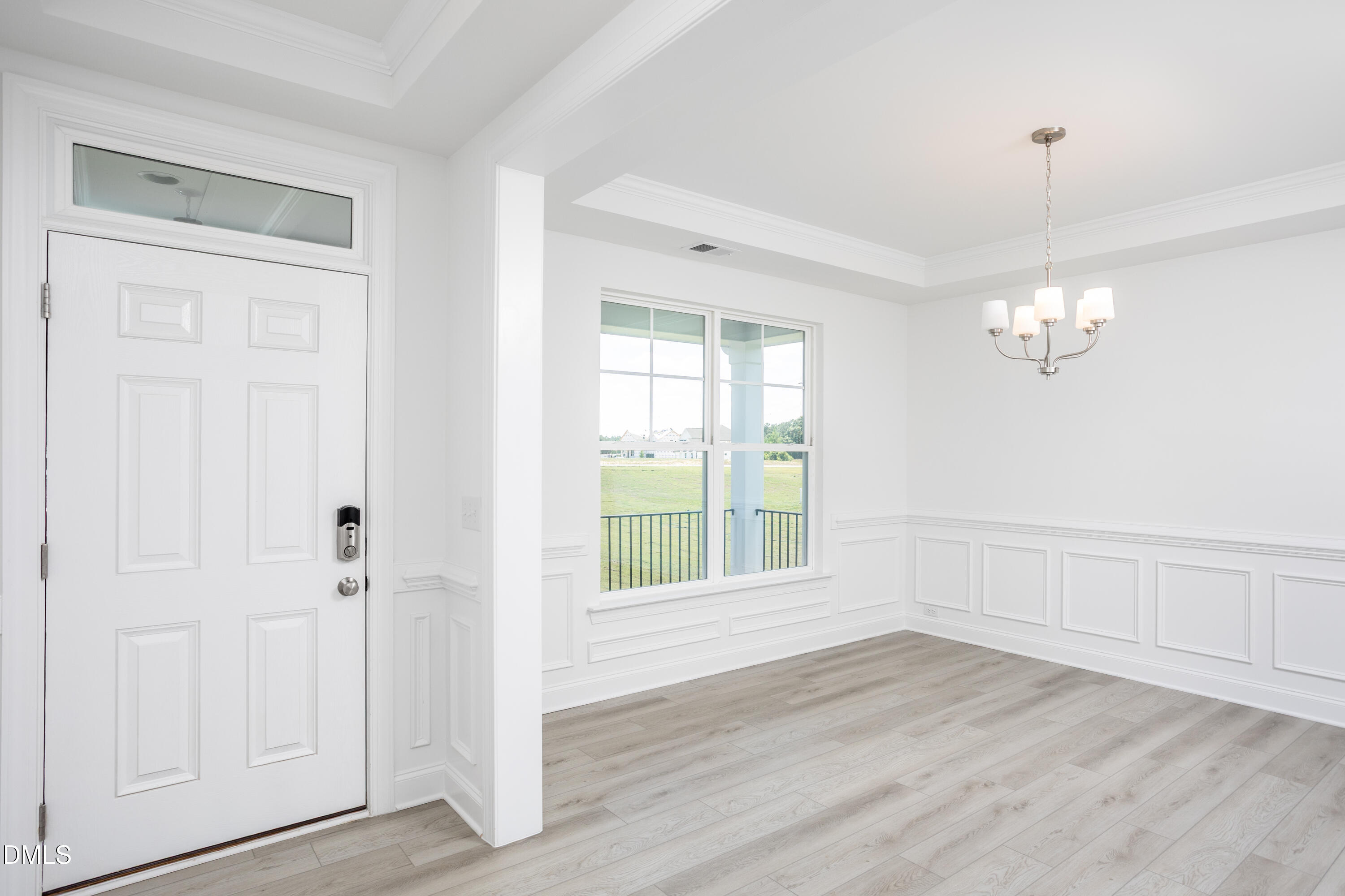 216 Cedar Rdg Trail Angier, NC 27501 - Photo 3 of 33 a view of an empty room with wooden floor and a window