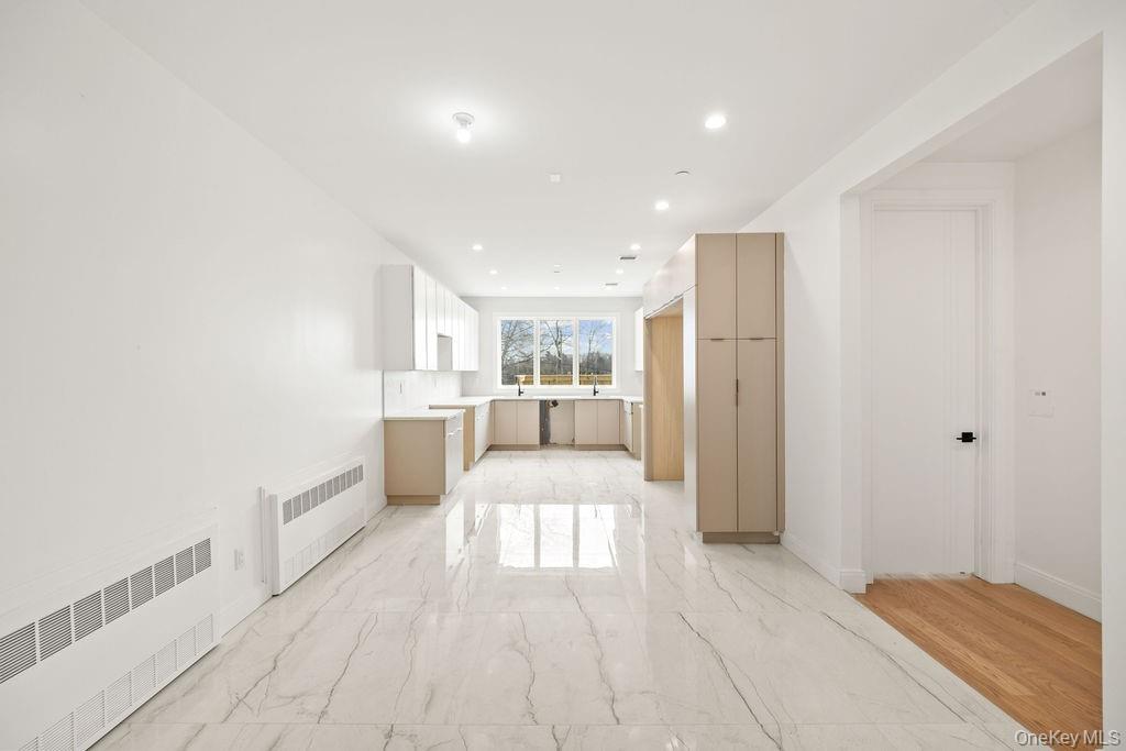 62 Blauvelt Road, Unit 202 Monsey, NY 10952 - Photo 14 of 34 a view of a kitchen with kitchen island white cabinets and wooden floor