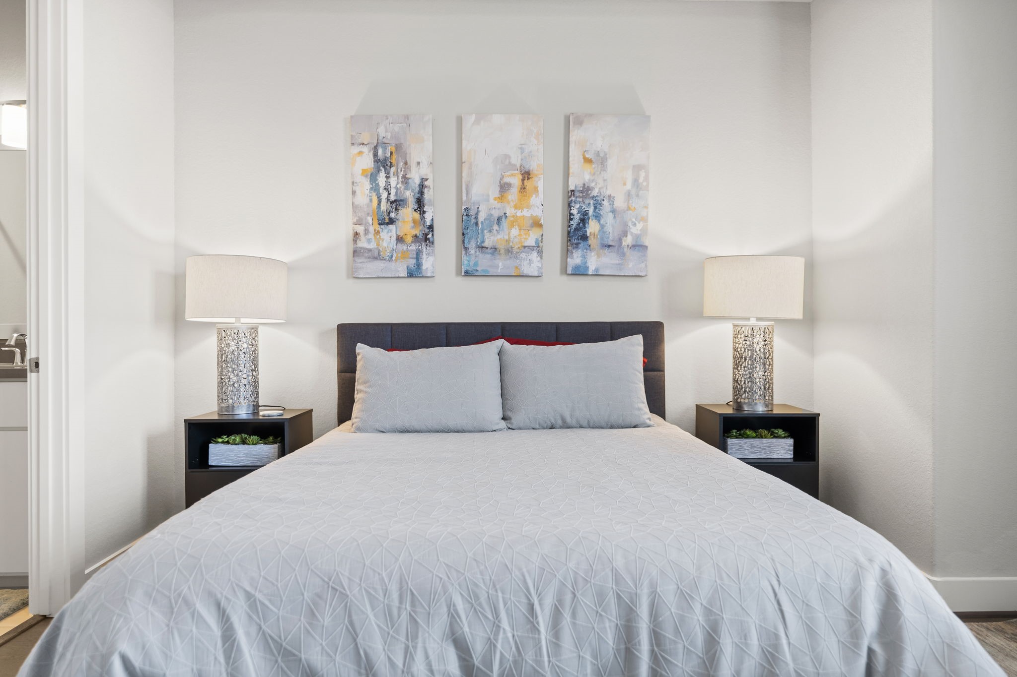 4227 Allen Street Houston, TX 77007 - Photo 20 of 30 a bedroom with a bed and a painting on the wall