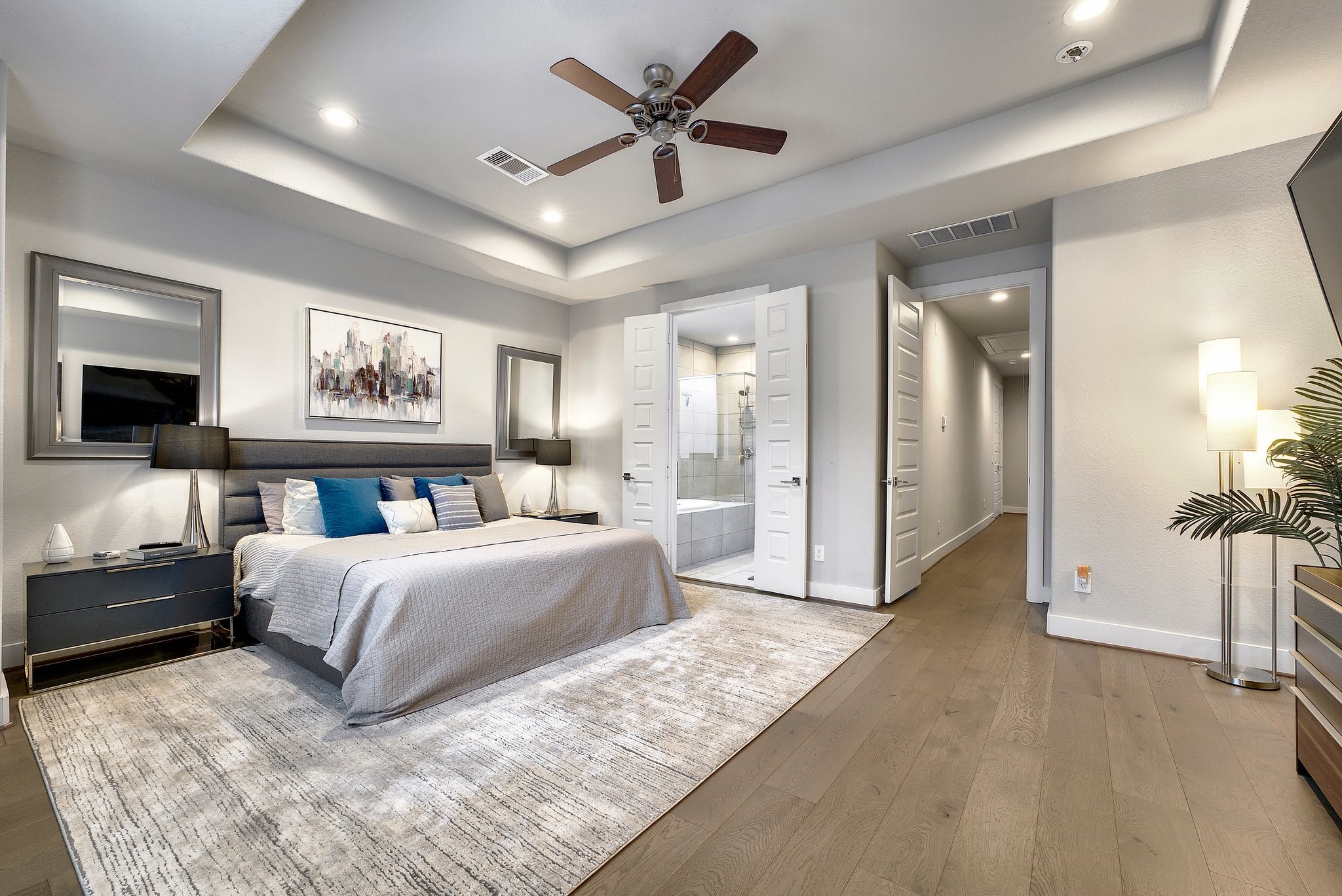 4227 Allen Street Houston, TX 77007 - Photo 22 of 30 a spacious bedroom with a large bed a ceiling fan and a rug