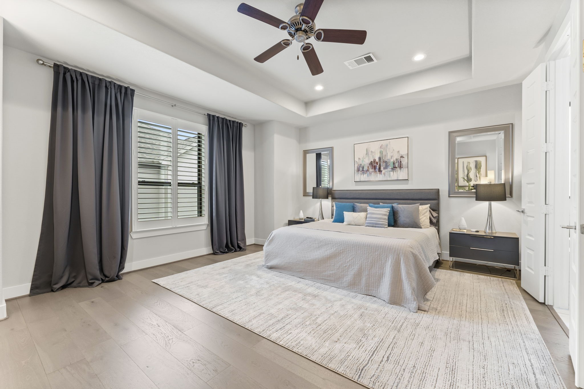 4227 Allen Street Houston, TX 77007 - Photo 23 of 30 a spacious bedroom with a large bed and a chandelier