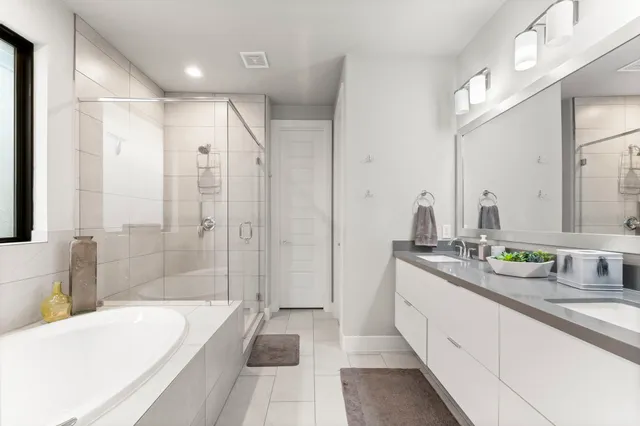 a spacious bathroom with a bathtub shower sink and a bath tub