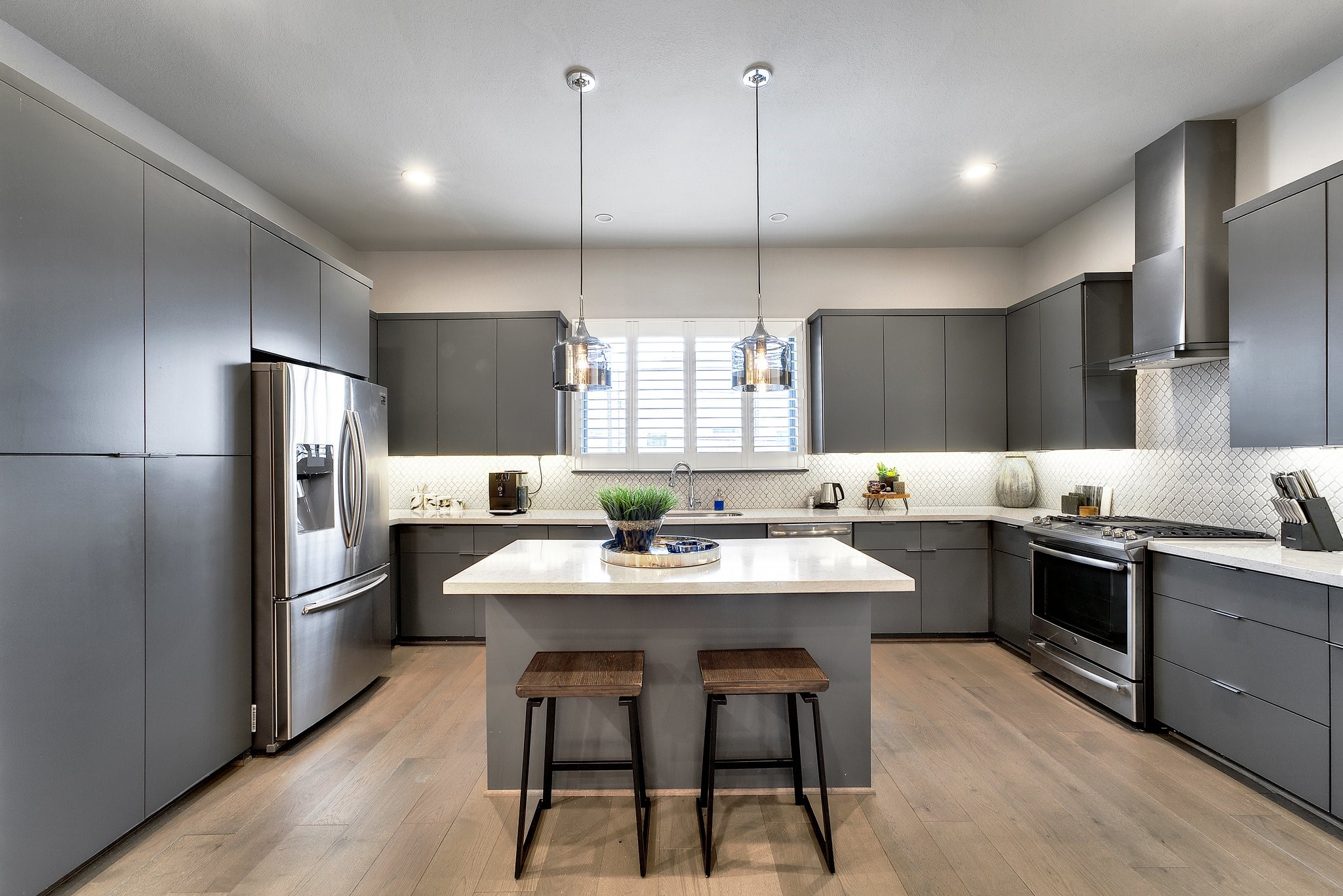 4227 Allen Street Houston, TX 77007 - Photo 10 of 30 a kitchen with stainless steel appliances granite countertop a sink a stove a refrigerator and island with wooden floor