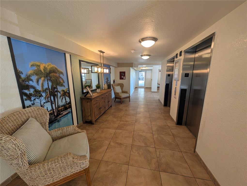 7070 Key Haven Road, Unit 602 Seminole, FL 33777 - Photo 14 of 48 a living room with furniture and a flat screen tv
