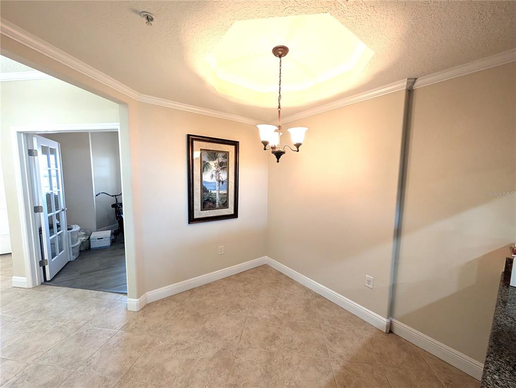 7070 Key Haven Road, Unit 602 Seminole, FL 33777 - Photo 17 of 48 a view of a hallway with a chandelier