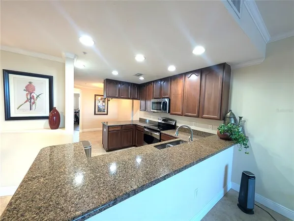 a large kitchen with stainless steel appliances kitchen island a large counter top