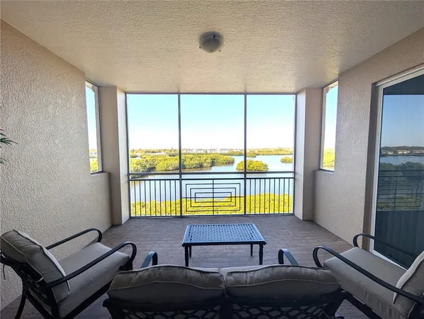a living room with furniture and a floor to ceiling window