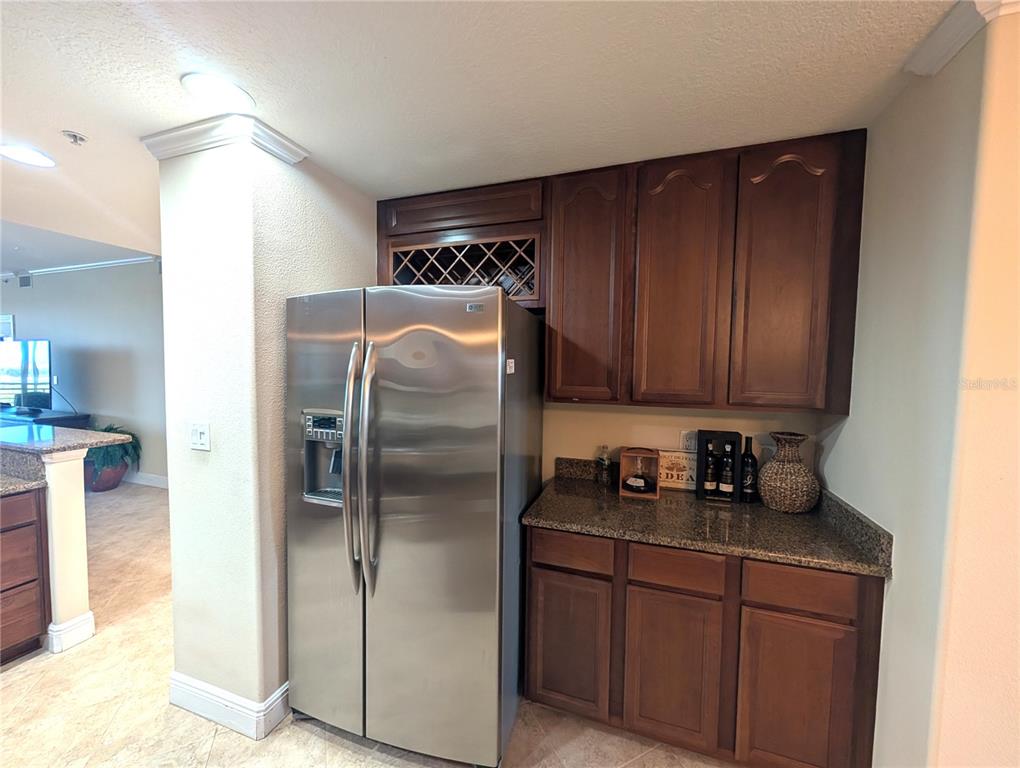 7070 Key Haven Road, Unit 602 Seminole, FL 33777 - Photo 23 of 48 a kitchen with stainless steel appliances granite countertop a refrigerator and a sink