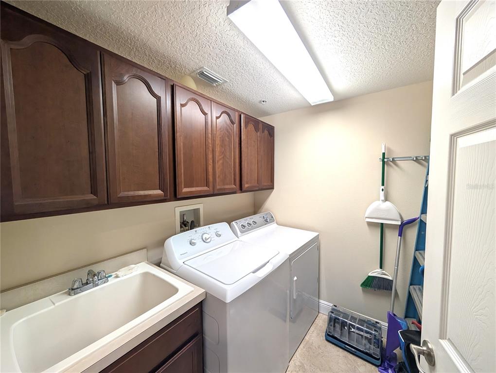 7070 Key Haven Road, Unit 602 Seminole, FL 33777 - Photo 25 of 48 a utility room with dryer and washer