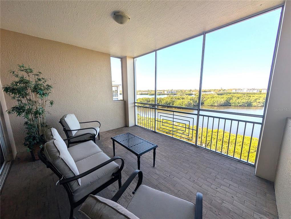 7070 Key Haven Road, Unit 602 Seminole, FL 33777 - Photo 28 of 48 a living room with furniture and a floor to ceiling window