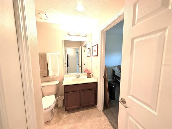 a bathroom with a toilet a sink and a mirror