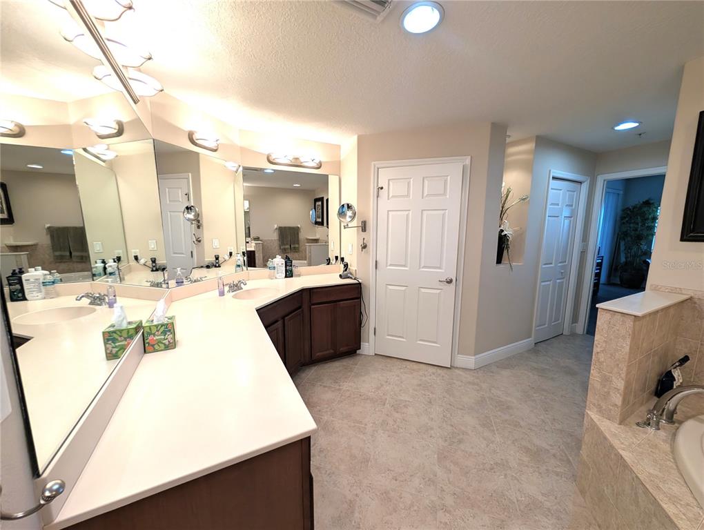 7070 Key Haven Road, Unit 602 Seminole, FL 33777 - Photo 36 of 48 a room with a sink vanity and a mirror