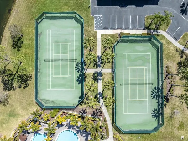an aerial view of residential houses with outdoor space and swimming pool