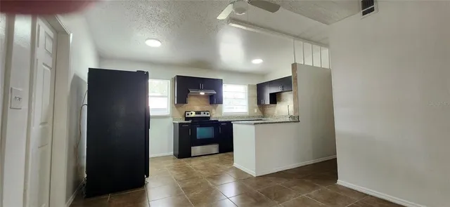 a kitchen with stainless steel appliances a refrigerator and a stove