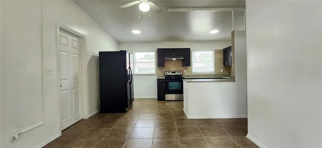 a kitchen with a refrigerator and a sink