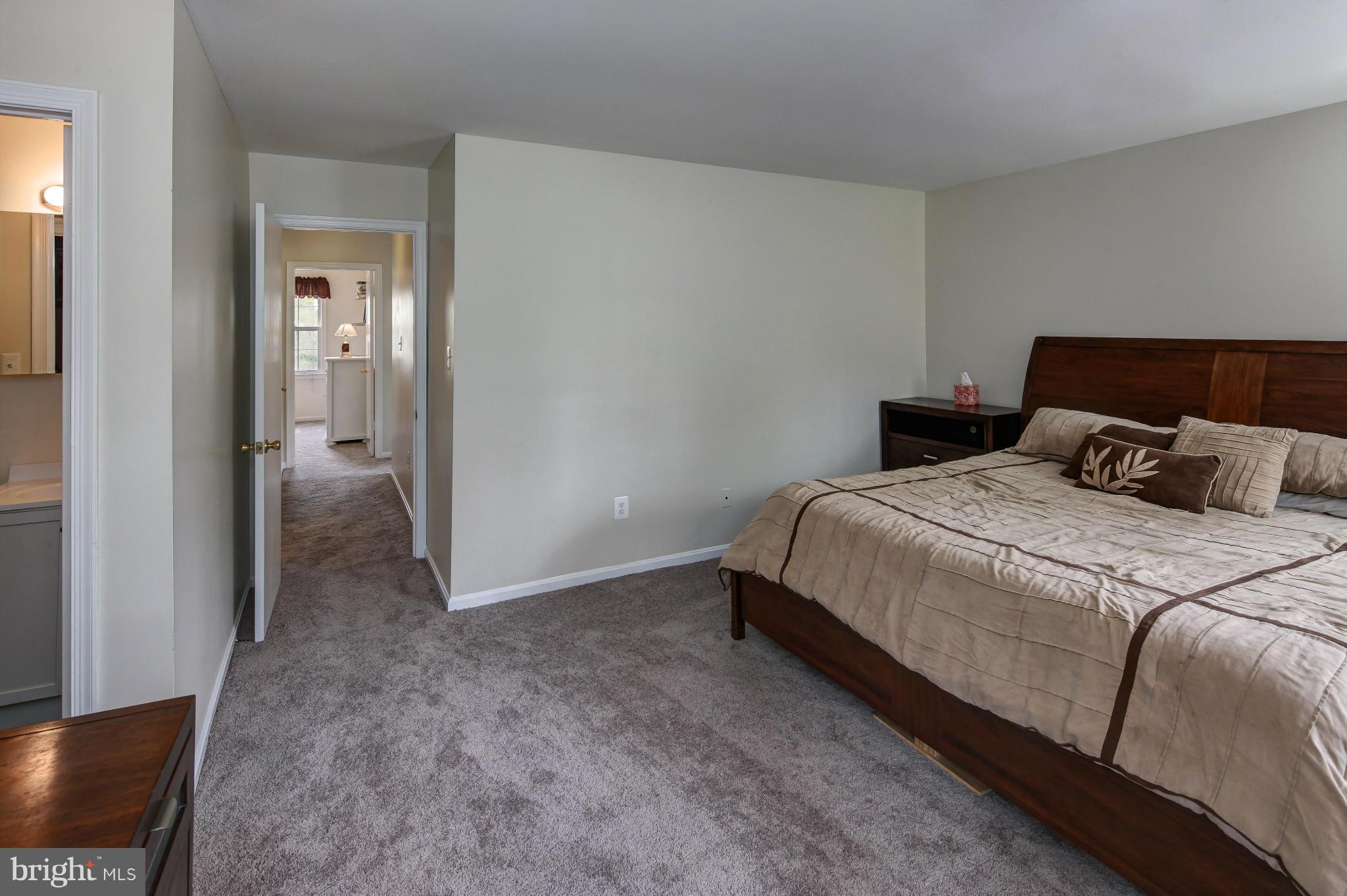 1530 Arbor View Road Silver Spring, MD 20902 - Photo 11 of 30 a bedroom with a bed and lamp