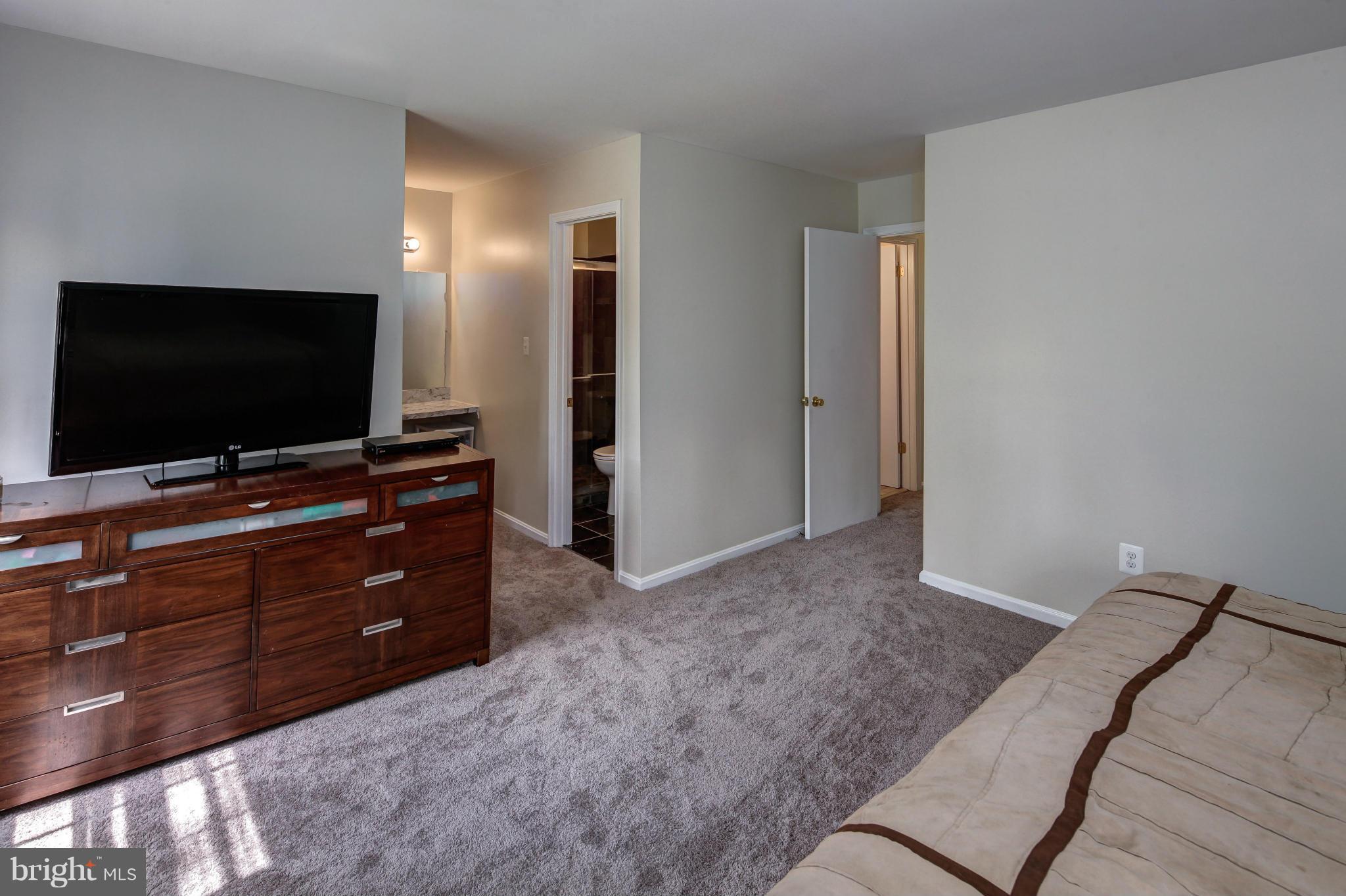 1530 Arbor View Road Silver Spring, MD 20902 - Photo 12 of 30 a bedroom with a bed and a flat screen tv