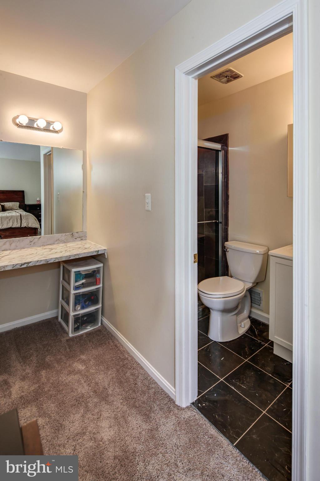 1530 Arbor View Road Silver Spring, MD 20902 - Photo 13 of 30 a bathroom with a toilet a sink and mirror