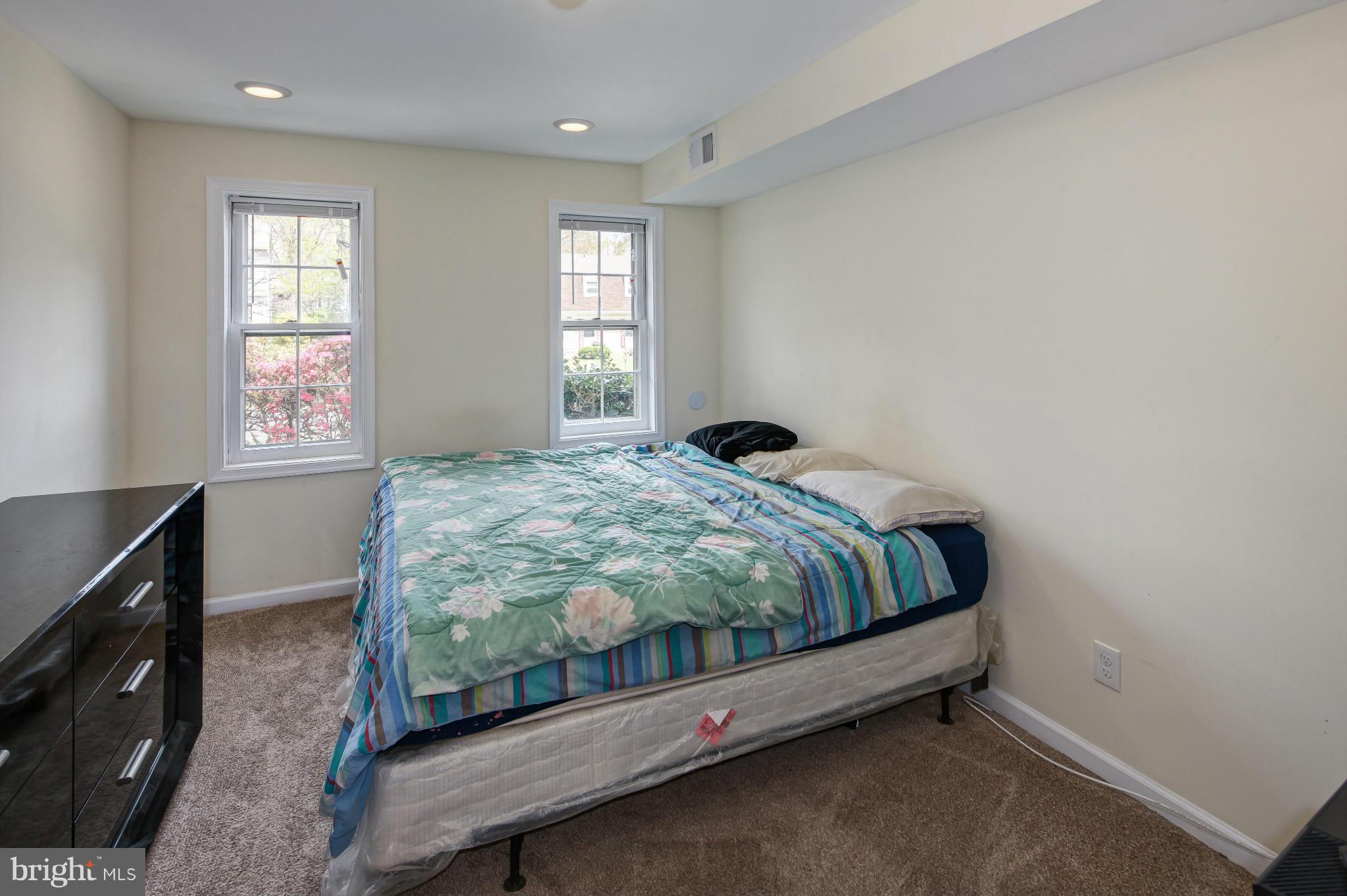 1530 Arbor View Road Silver Spring, MD 20902 - Photo 14 of 30 a bed sitting in a bedroom next to a window