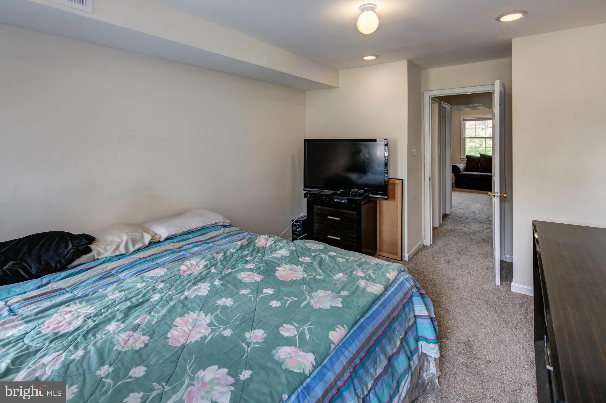 1530 Arbor View Road Silver Spring, MD 20902 - Photo 15 of 30 a bedroom with a bed and a flat screen tv