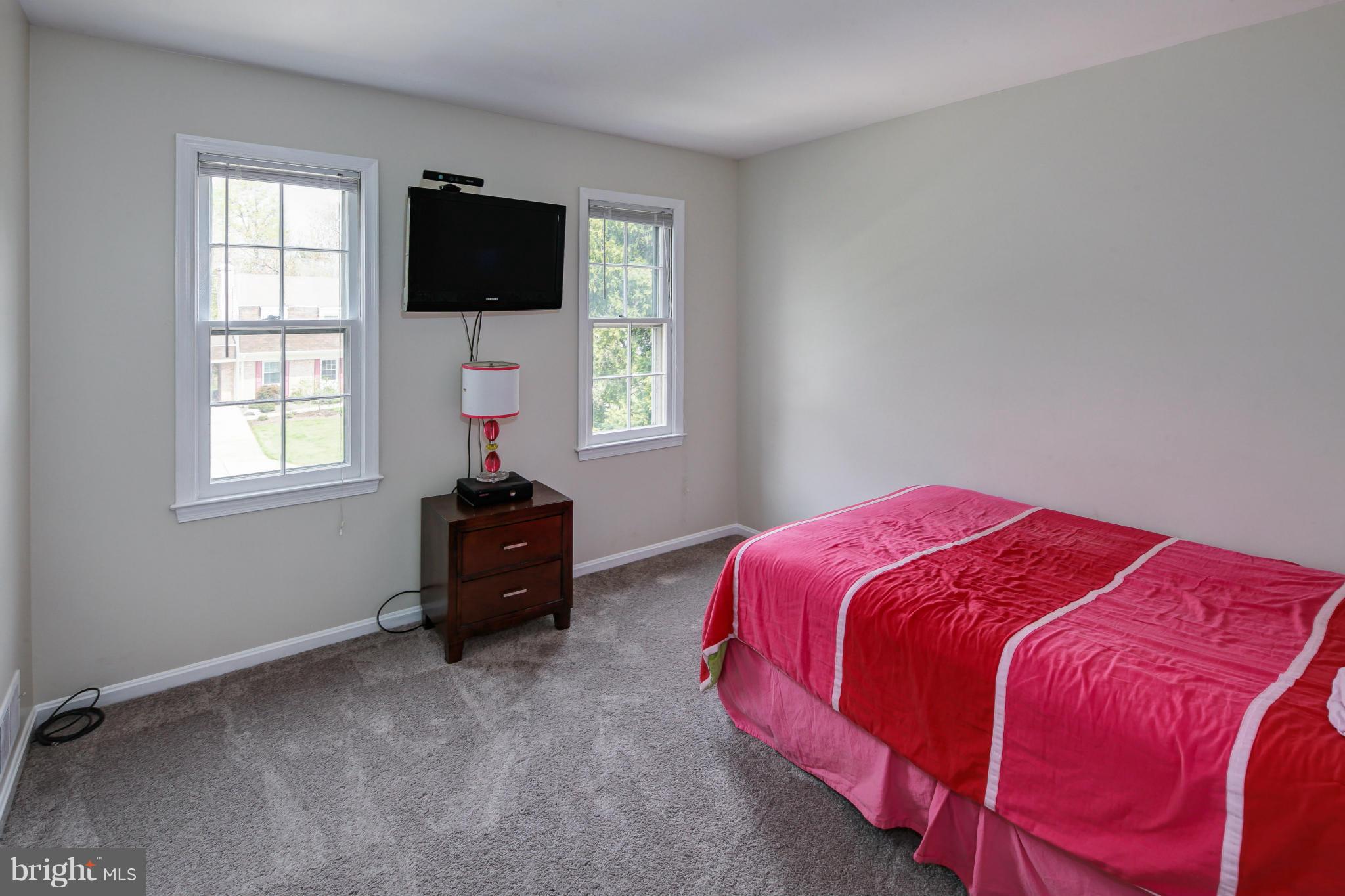 1530 Arbor View Road Silver Spring, MD 20902 - Photo 18 of 30 a bedroom with a bed and a flat screen tv