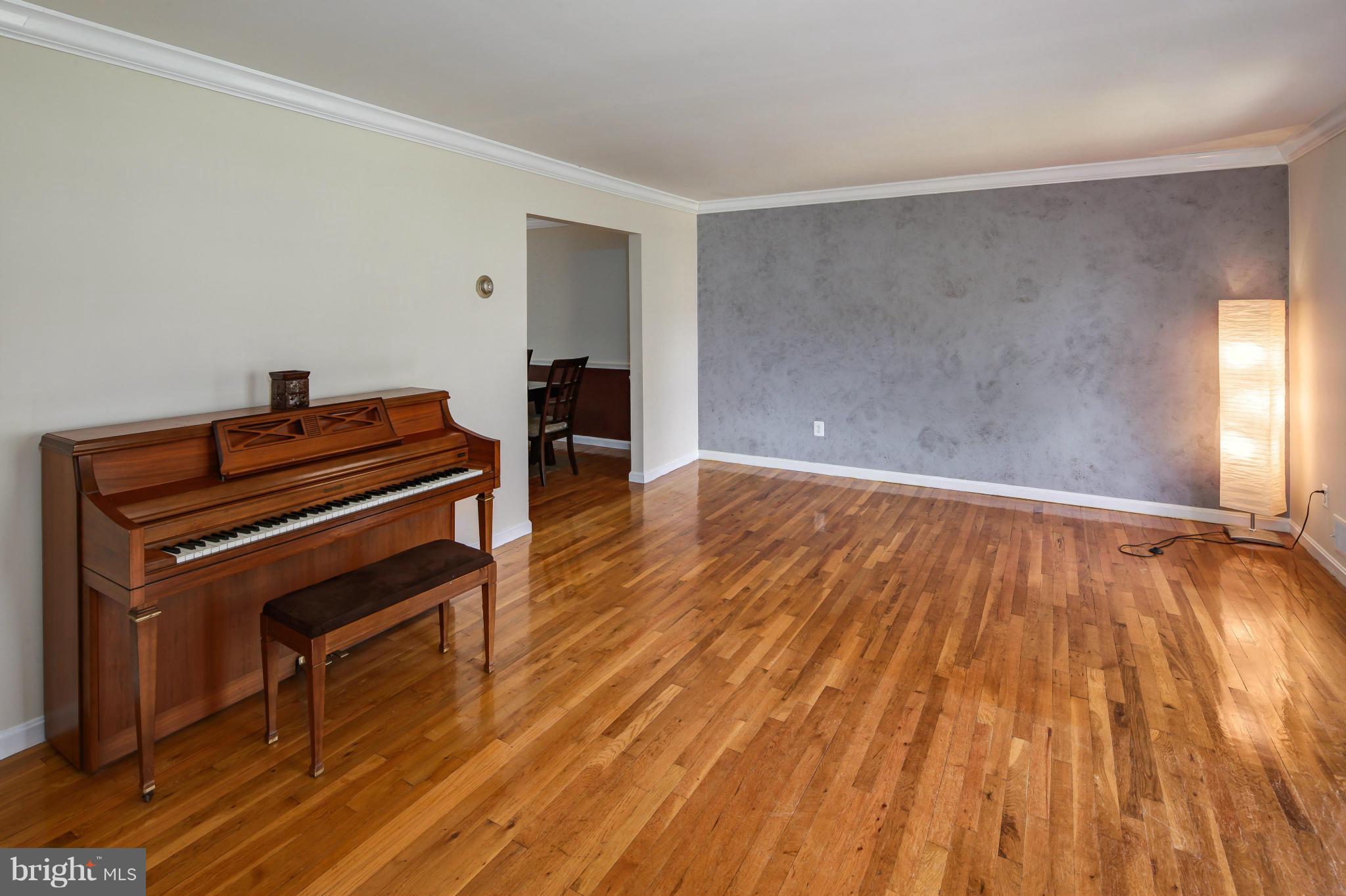 1530 Arbor View Road Silver Spring, MD 20902 - Photo 3 of 30 a room with wooden floor and a piano