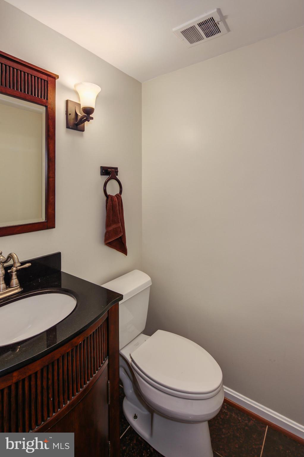 1530 Arbor View Road Silver Spring, MD 20902 - Photo 25 of 30 a bathroom with a toilet a sink and mirror