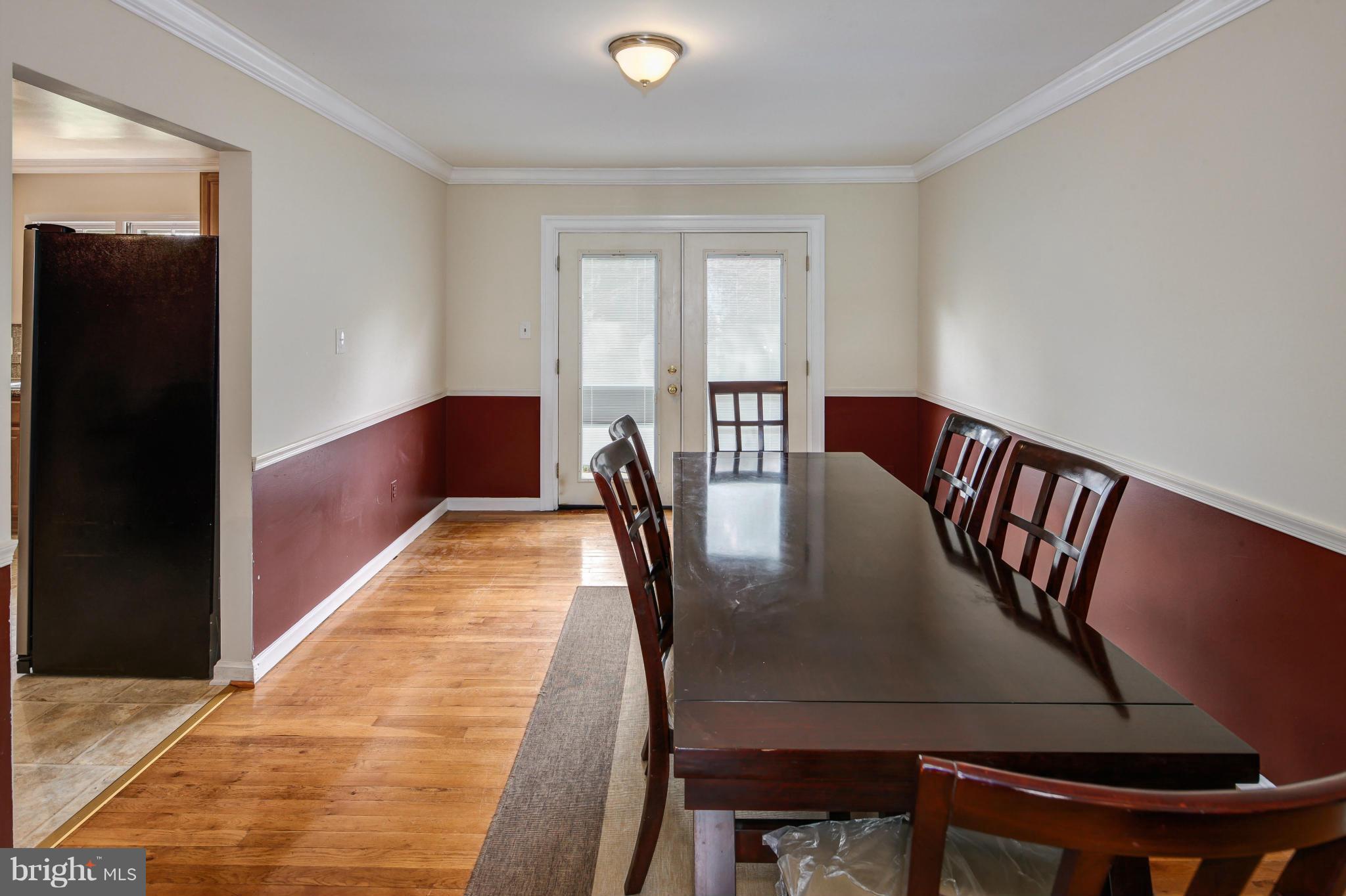 1530 Arbor View Road Silver Spring, MD 20902 - Photo 5 of 30 a view of a dining room with furniture and a floor to ceiling window